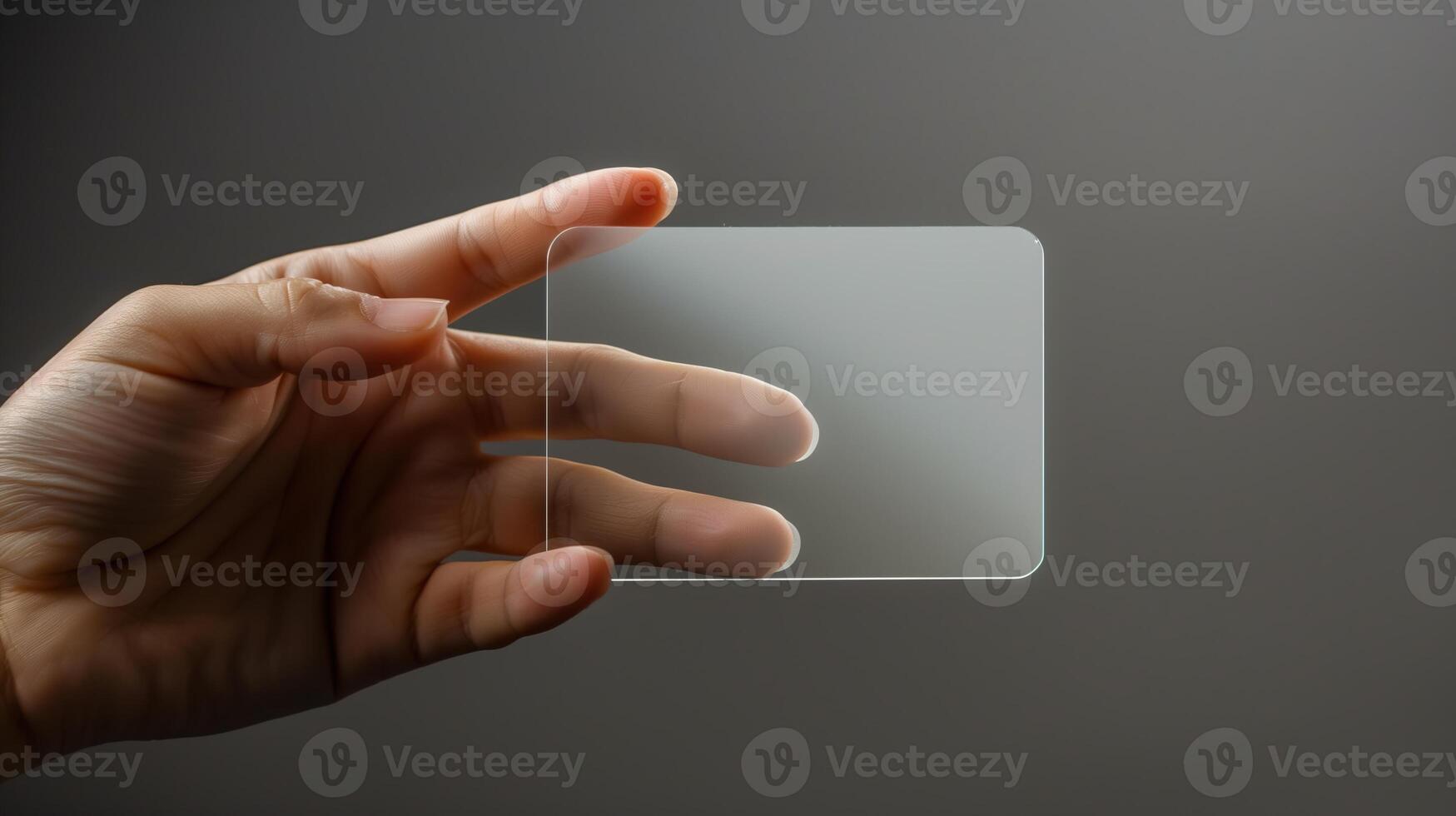 A mockup featuring a hand holding a blank translucent card photo