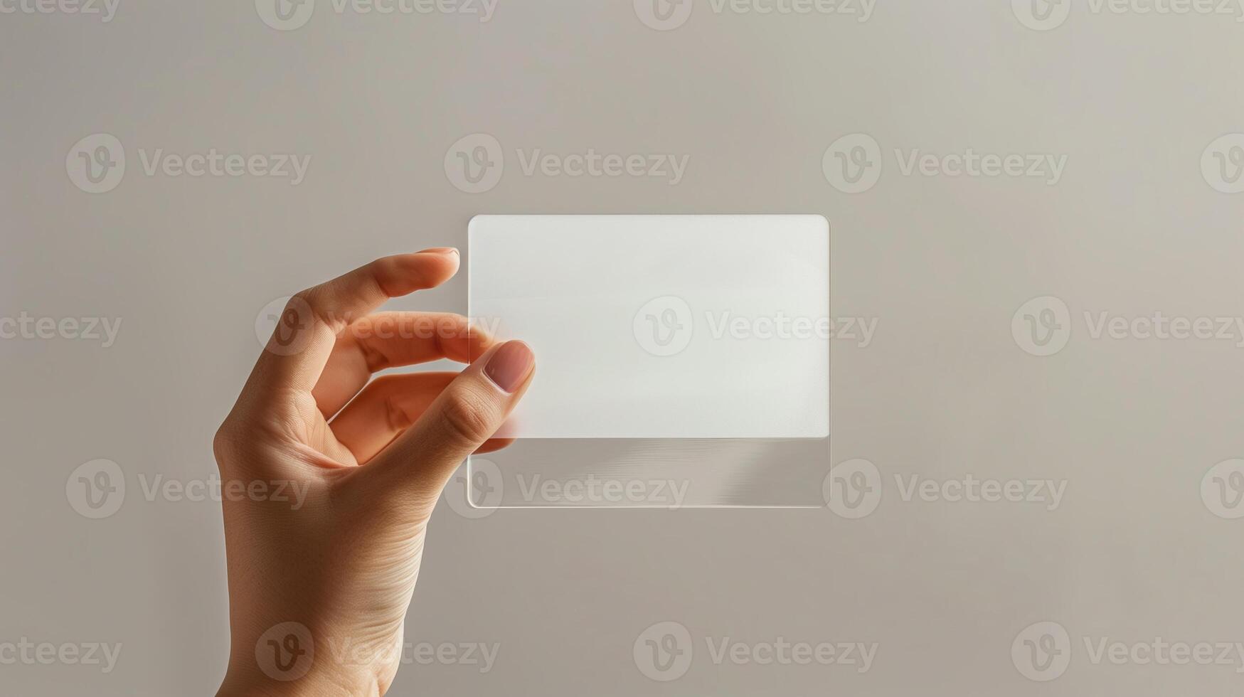 A mockup featuring a hand holding a blank translucent card photo