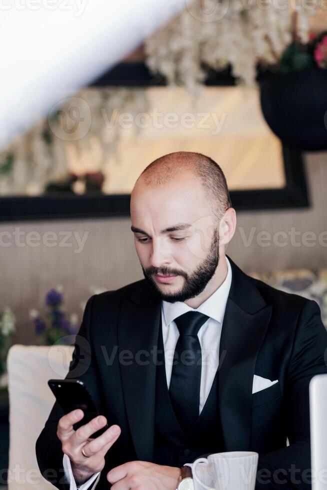 Businessman using mobile phone app texting in office photo