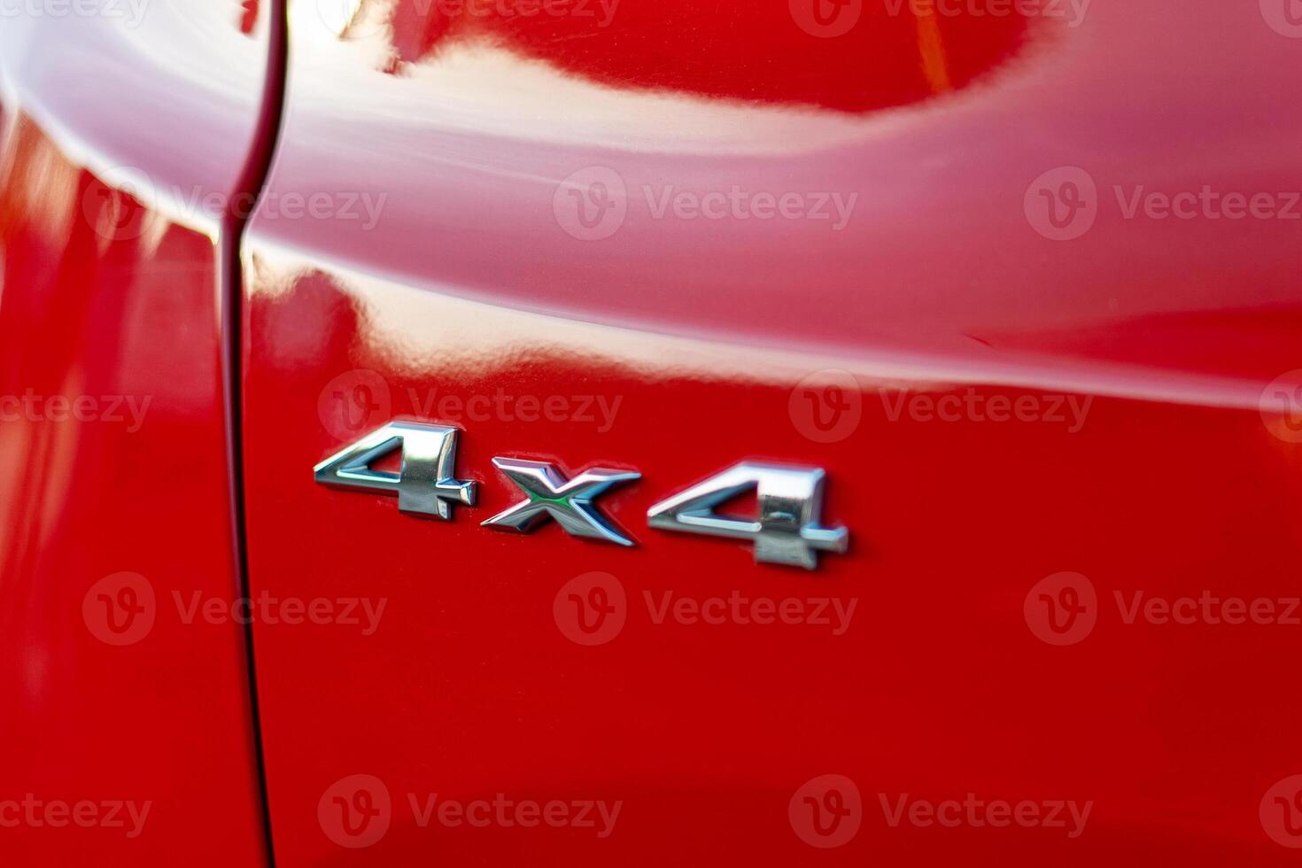 Grunge track 4x4 letters. The designation of all-wheel drive on SUVs. Unique off-road inscription in silver on a red back. photo