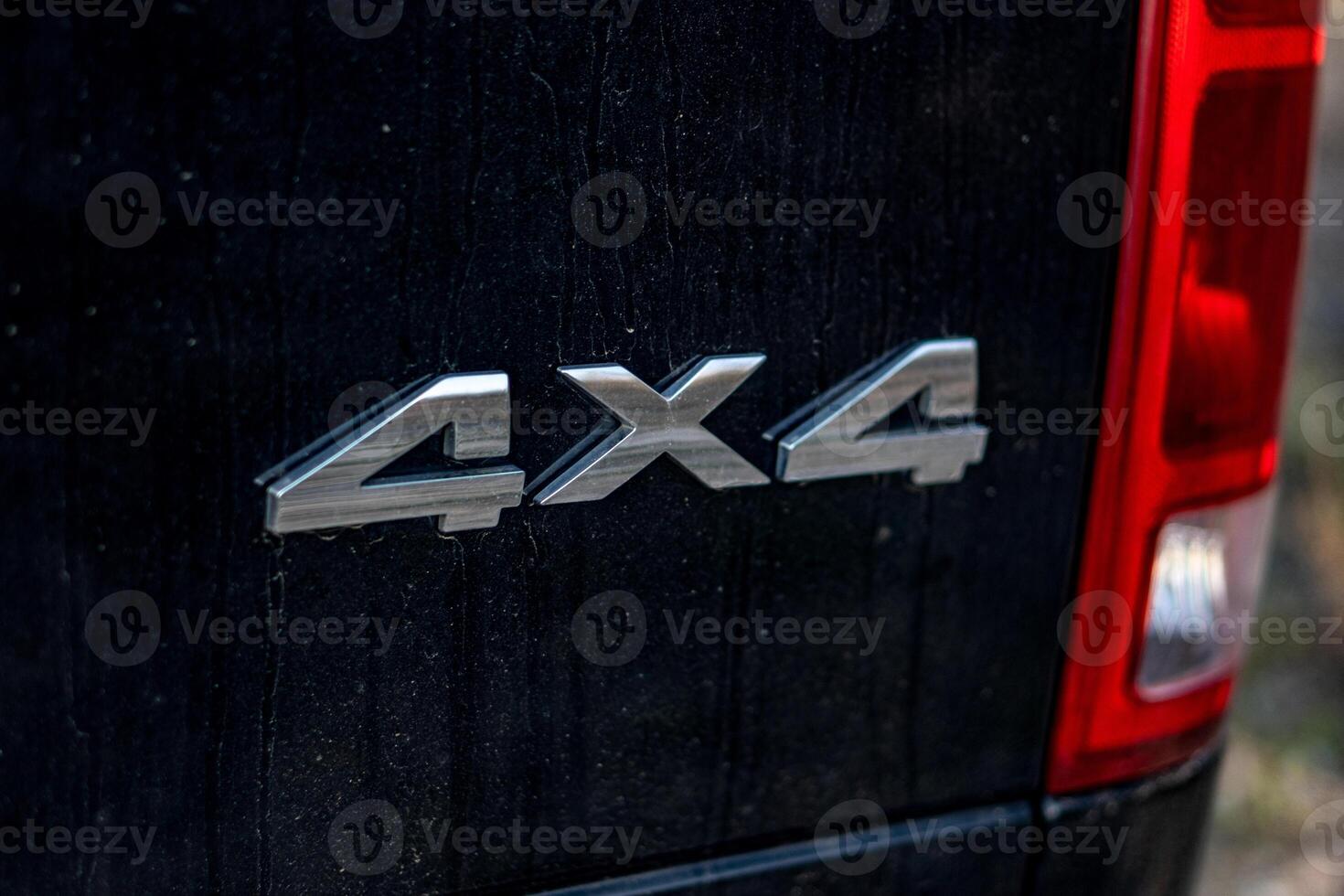 Grunge track 4x4 letters. The designation of all-wheel drive on SUVs. Unique off-road inscription in silver on a black back. photo