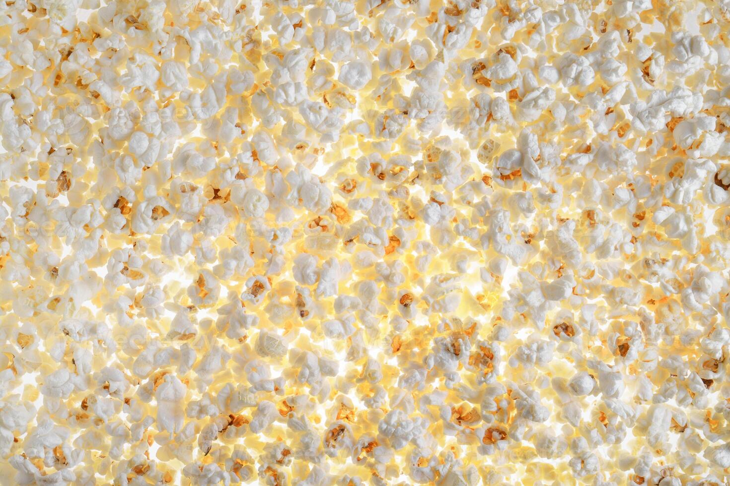 White fresh popcorn lying evenly on the surface. Popcorn back photo
