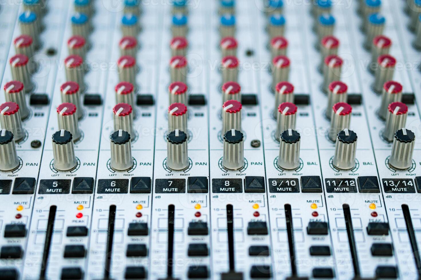 Close-up of the handles and sliders of an audio mixer. Blurred back. photo