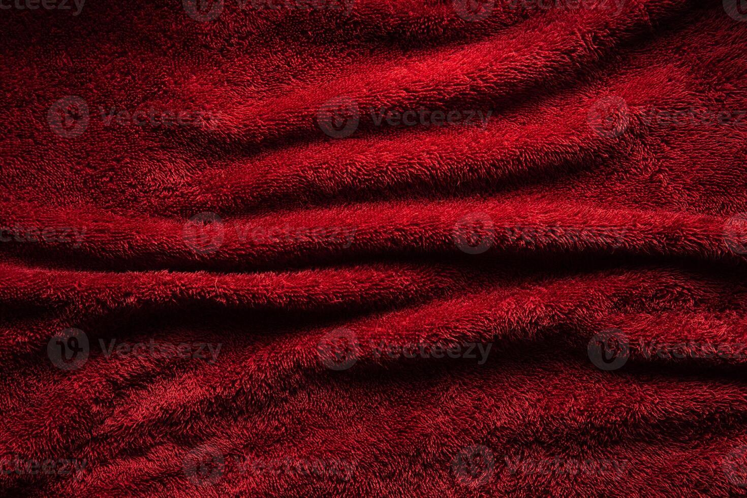 A soft red terry towel. Burgundy texture back. Underlay and free space for text. photo