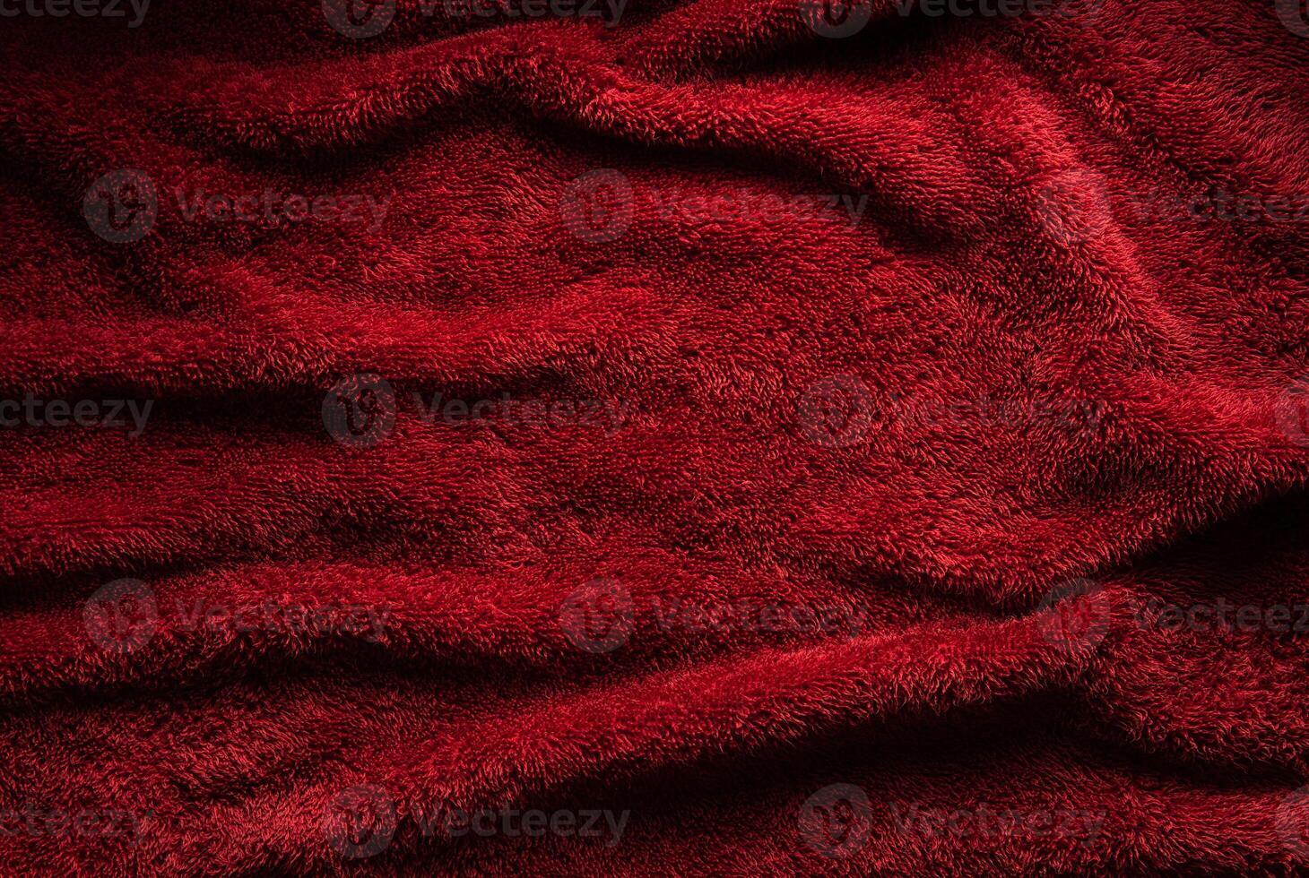A soft red terry towel. Burgundy texture back. Underlay and free space for text. photo