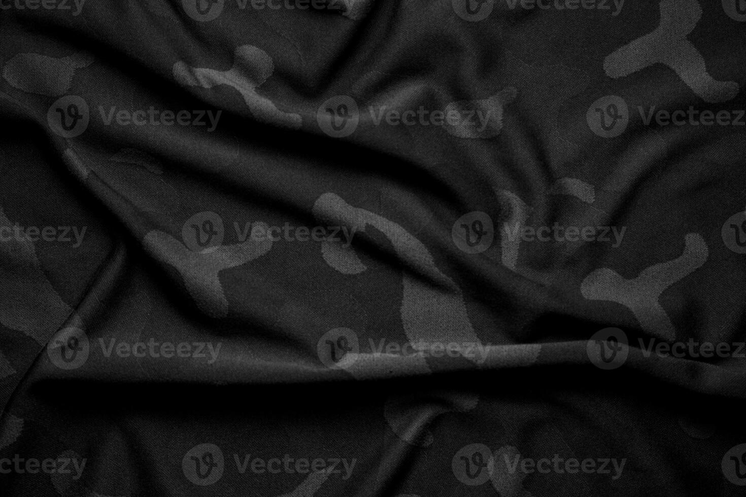 Camouflage pattern. Trendy dark gray camouflage fabric. Military texture. Dark back. photo