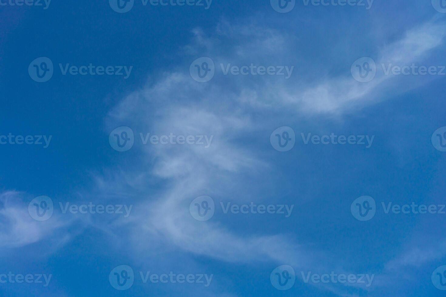 White clouds on a back of blue sky. Clear sky with fluffy light clouds. photo