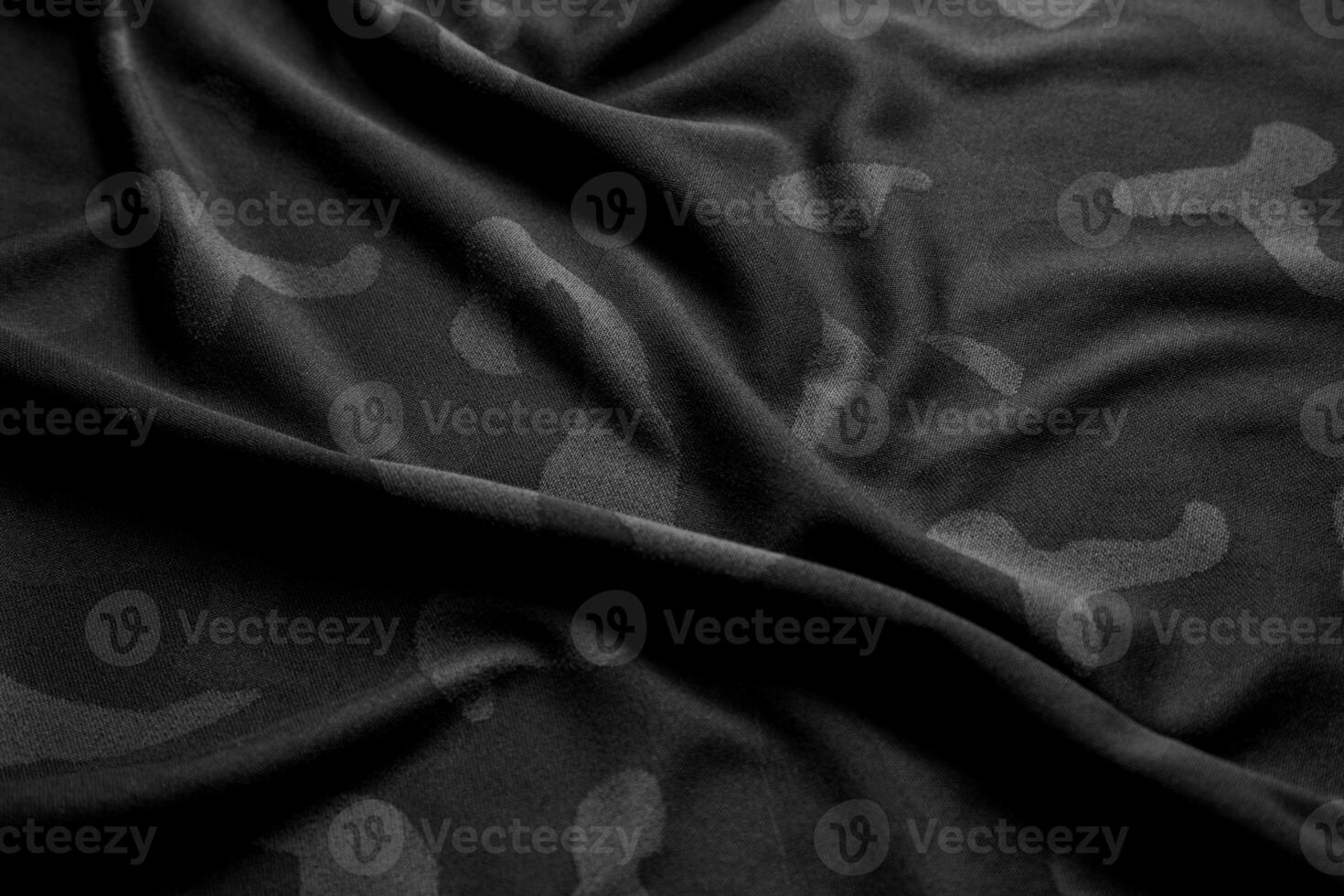 Camouflage pattern. Trendy dark gray camouflage fabric. Military texture. Dark back. photo