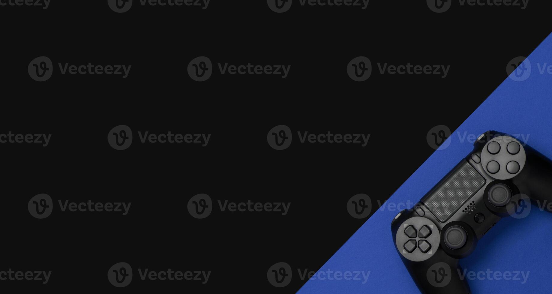 black gamepad on a black blue. Gaming concept photo