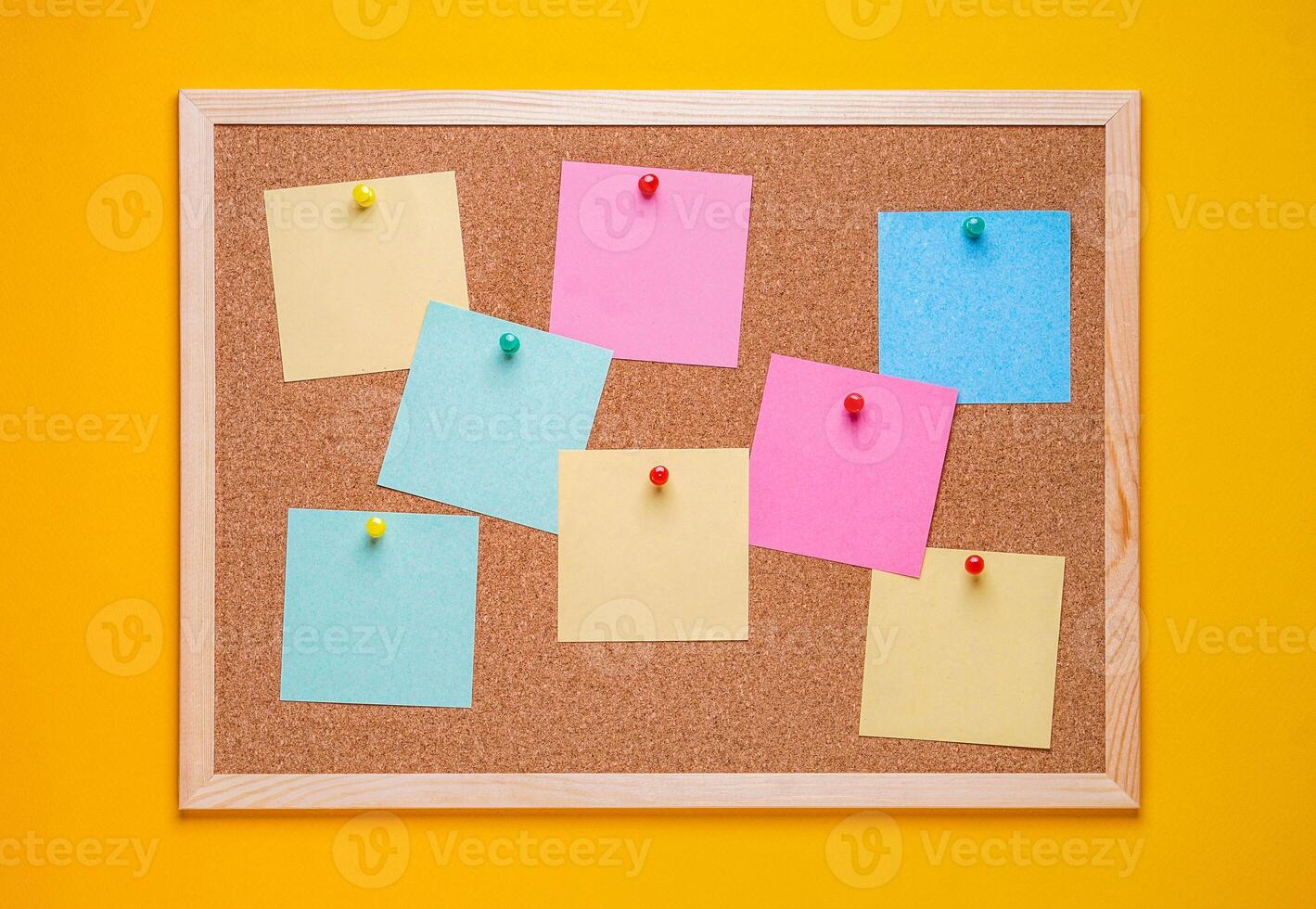 multicolored corkboard stickers pinned with buttons. yellow background. photo