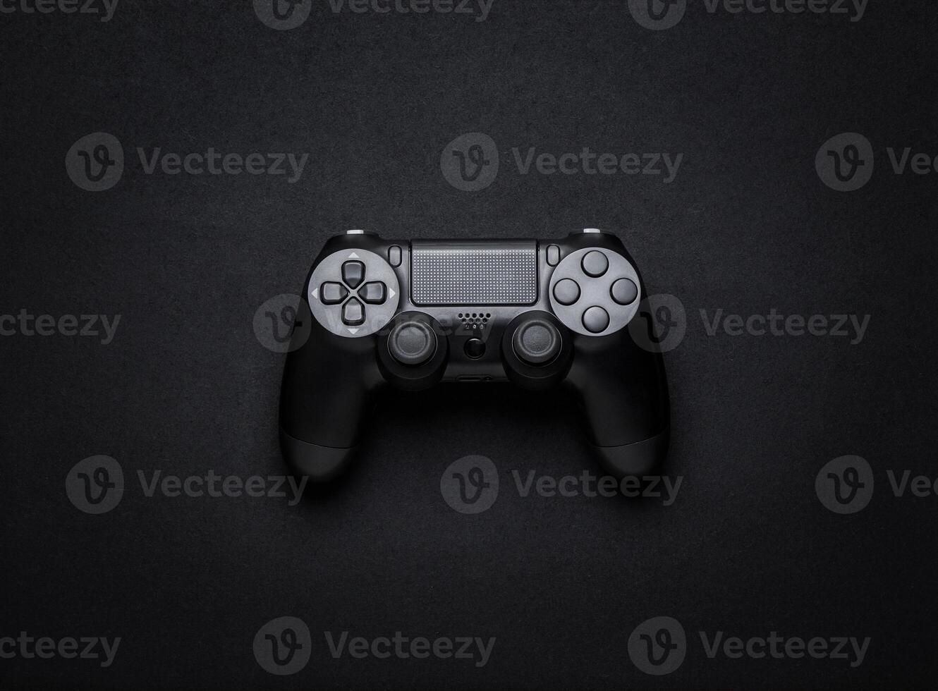 black wireless gamepad on a black background photo