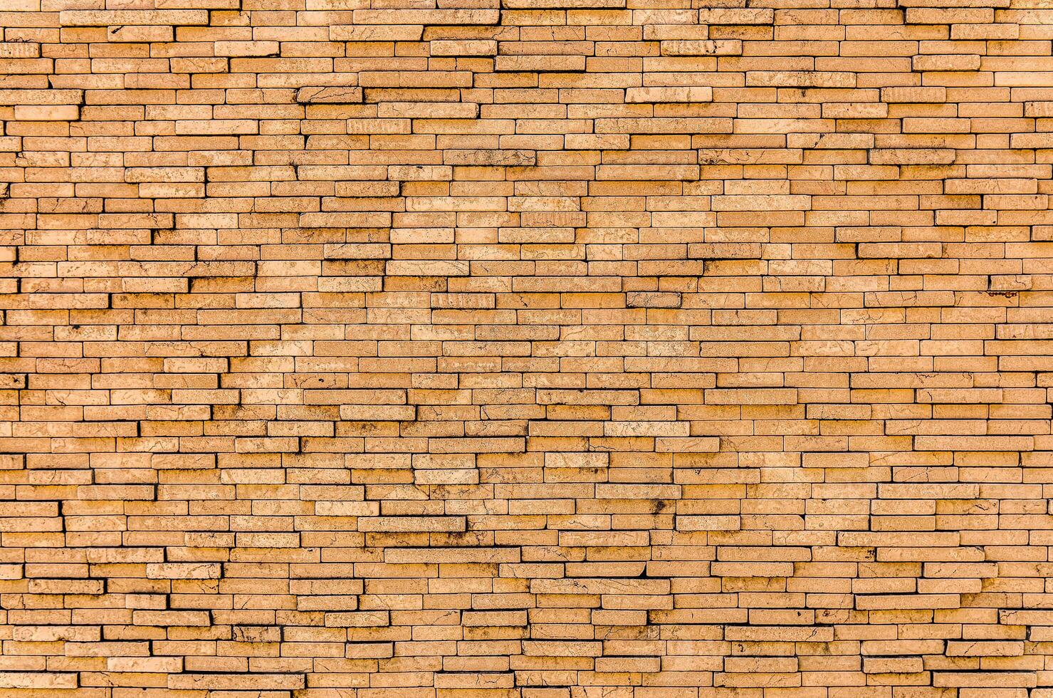 Yellow brick wall. Background of rectangular gray tiles of different sizes. photo