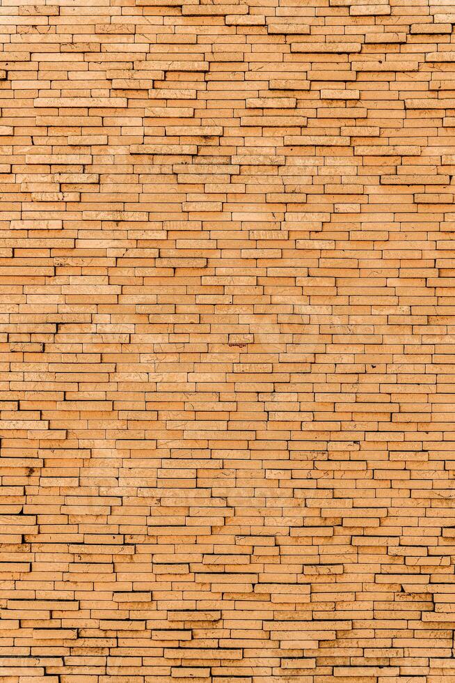 Yellow brick wall. Background of rectangular gray tiles of different sizes. photo