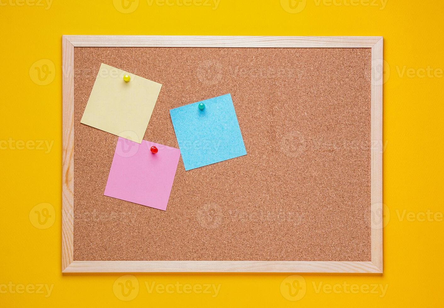multicolored corkboard stickers pinned with buttons. yellow background. photo
