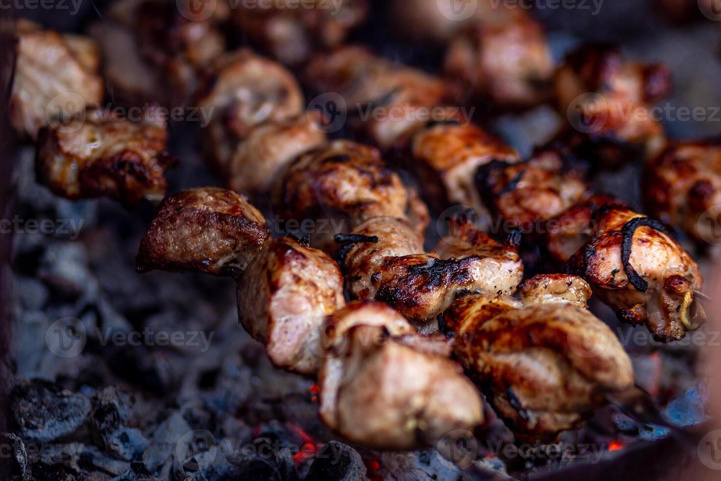 Fresh shish kebab on skewers is fried on the grill. Grilled meat on skewers. photo