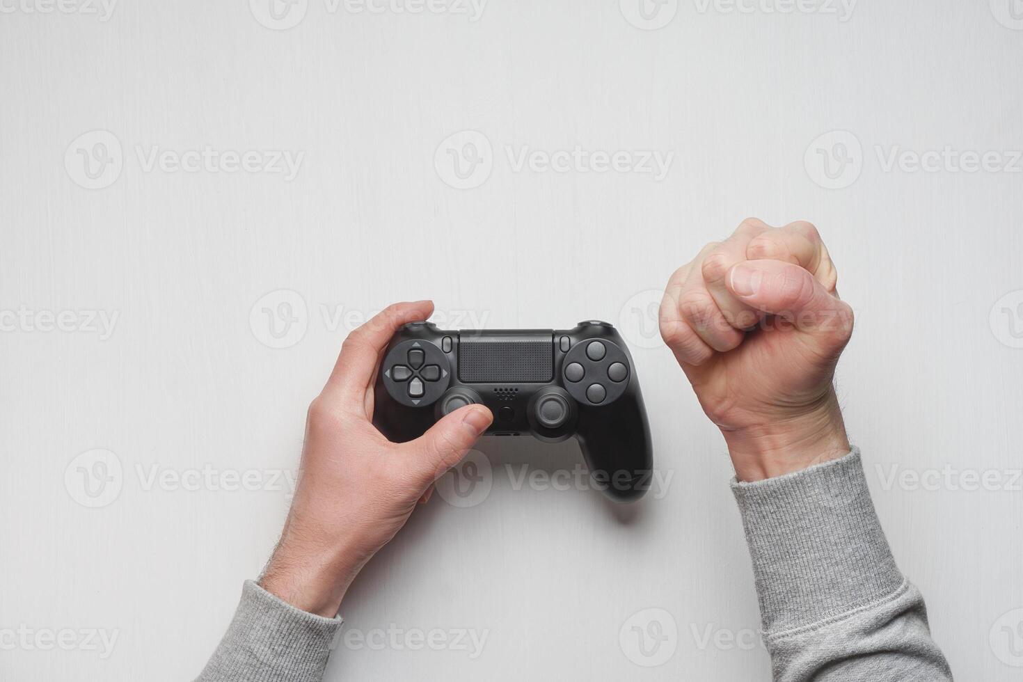 Hand hold new joystick isolated. Gamer play game with gamepad controller. Gaming man holding simulator joypad. Person with keypad joystic in arms. Sleeve hands hold toy equipment. Modern manipulator. photo