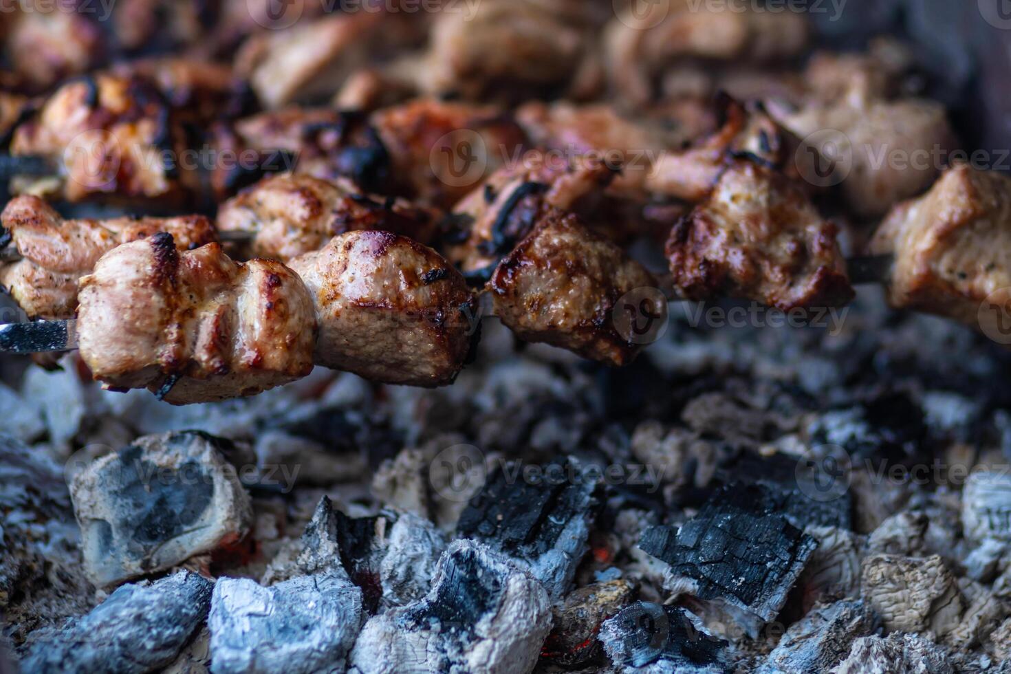 Fresh shish kebab on skewers is fried on the grill. Grilled meat on skewers. photo