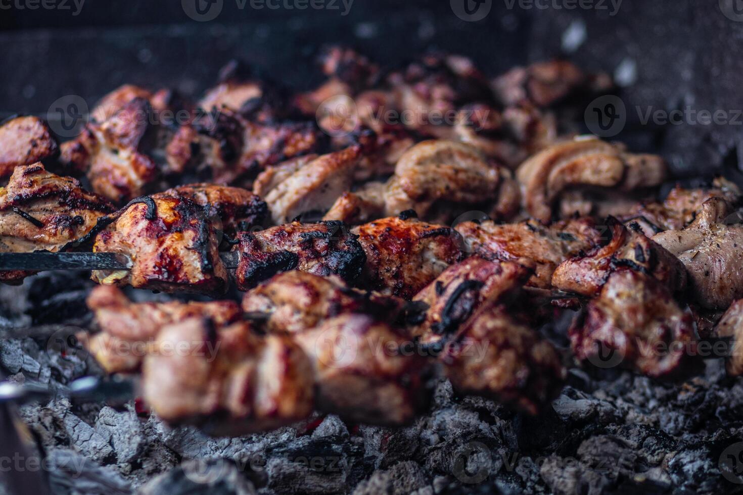 Fresh shish kebab on skewers is fried on the grill. Grilled meat on skewers. photo
