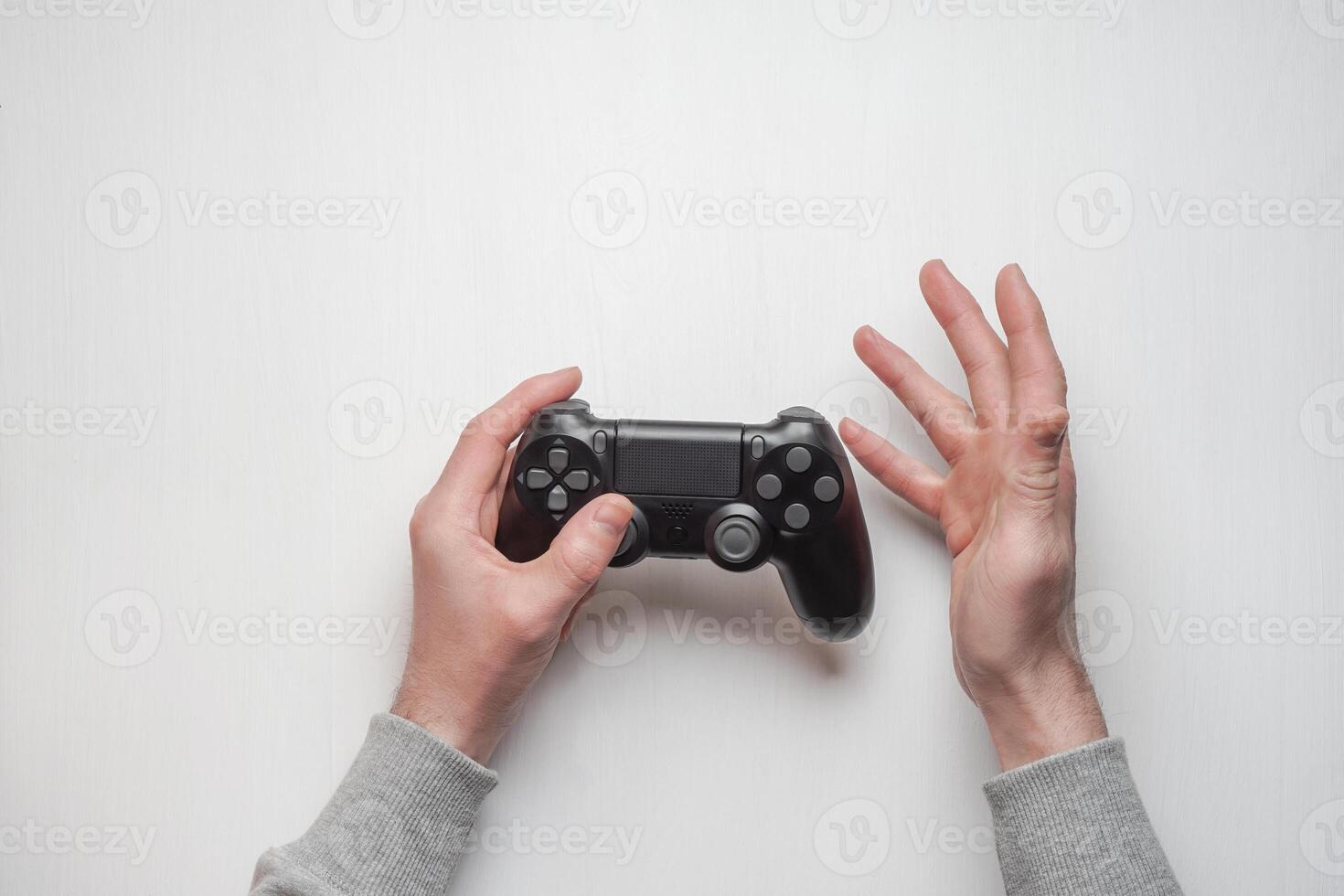 Hand hold new joystick isolated. Gamer play game with gamepad controller. Gaming man holding simulator joypad. Person with keypad joystic in arms. Sleeve hands hold toy equipment. Modern manipulator. photo