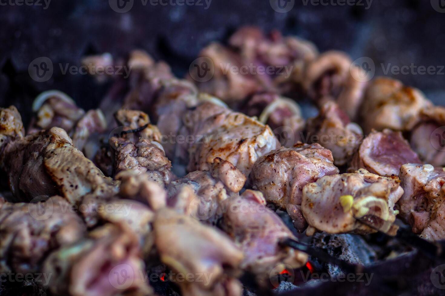 Fresh shish kebab on skewers is fried on the grill. Grilled meat on skewers. photo