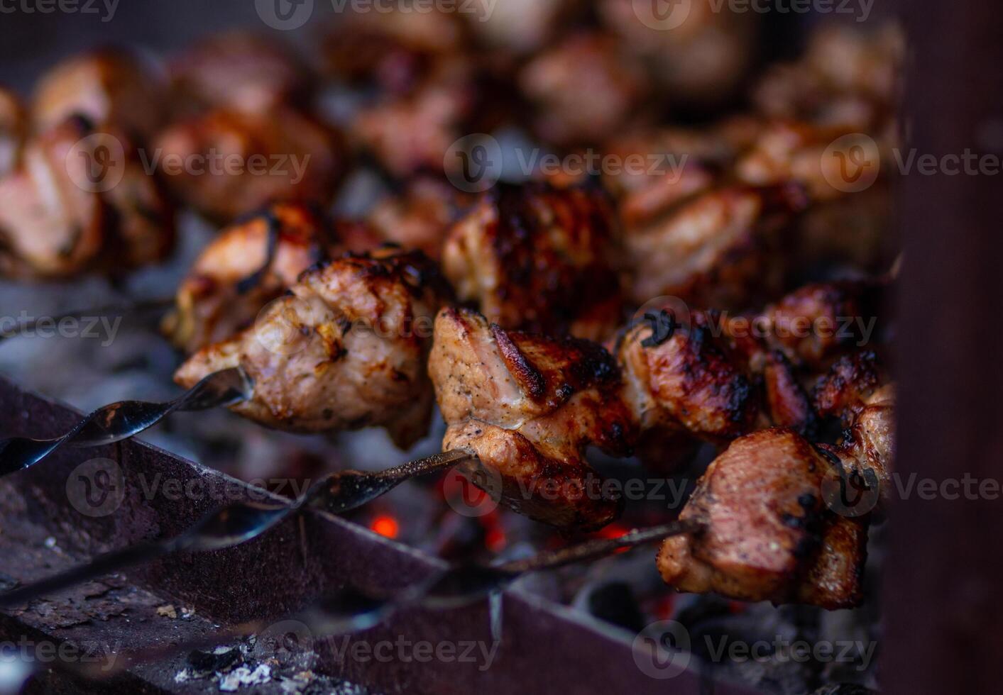 Grilled meat on skewers. Fresh shish kebab on skewers is fried on the grill. Cooking. photo