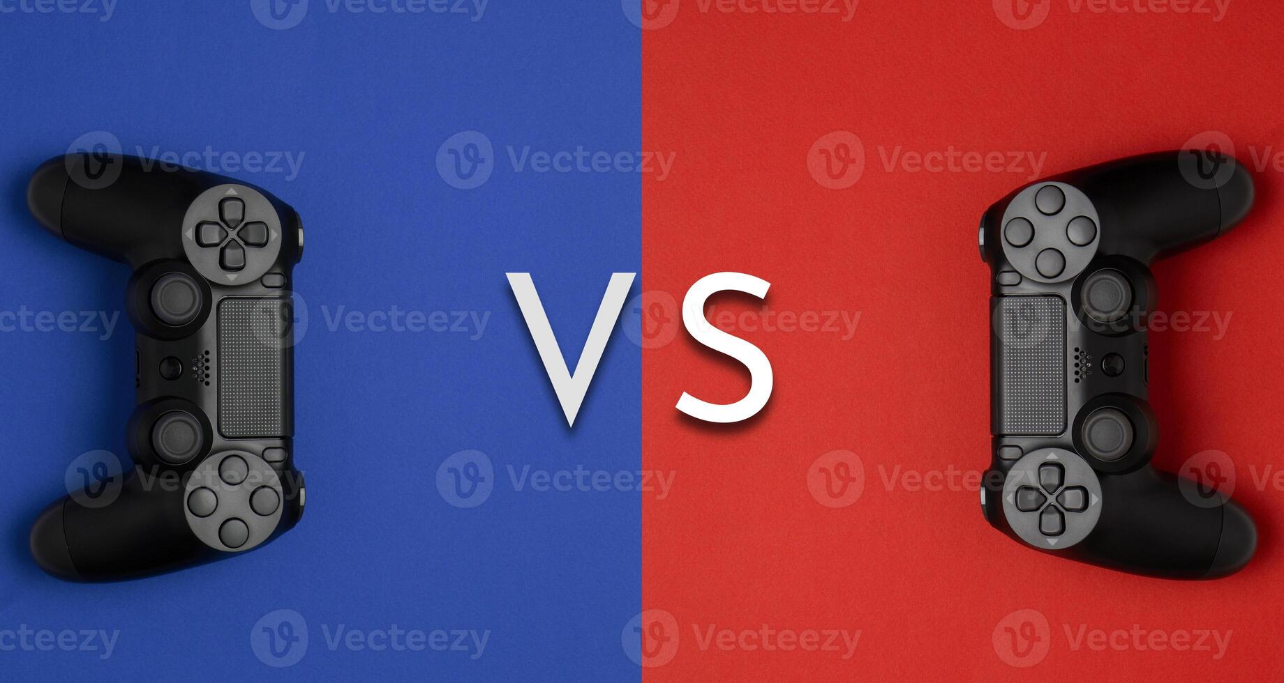 black gamepads on a red blue background. Gaming concept. Player versus plauer. Player vs player. photo