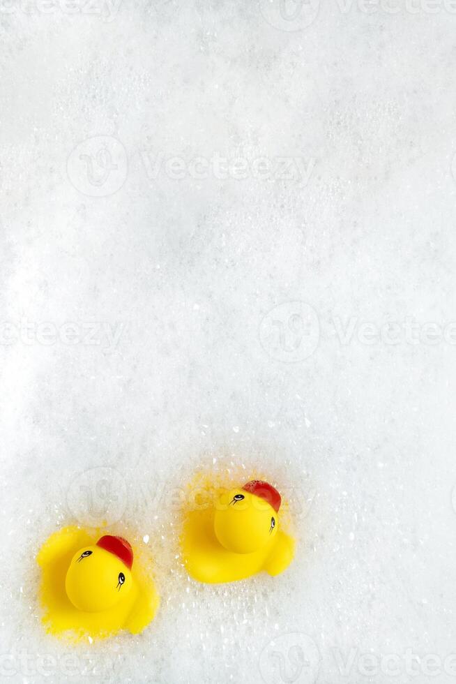 High Angle View of yellow rubber duck in bath swimming in foam w photo