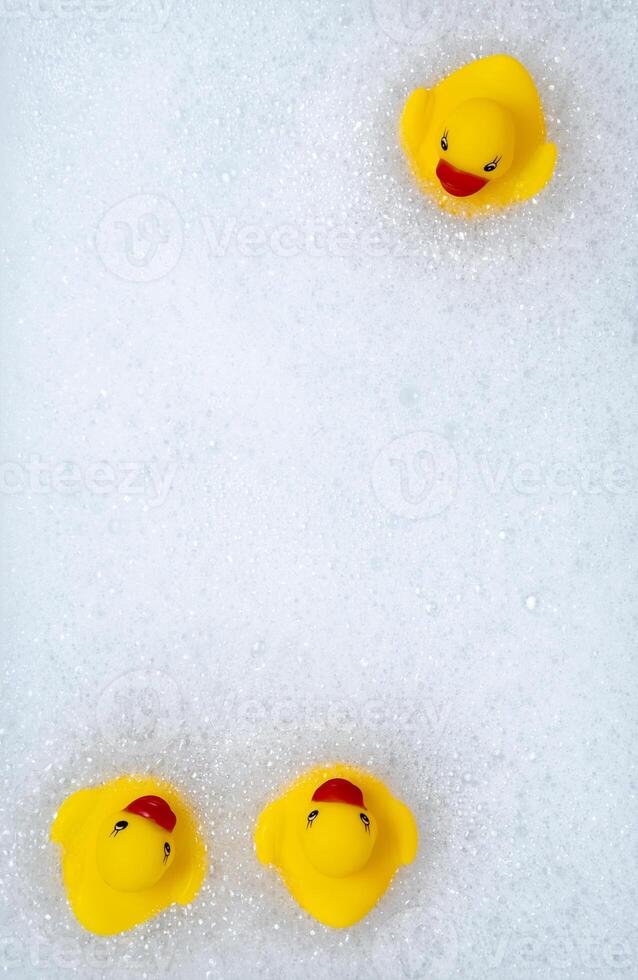 High Angle View of yellow rubber duck in bath swimming in foam w photo