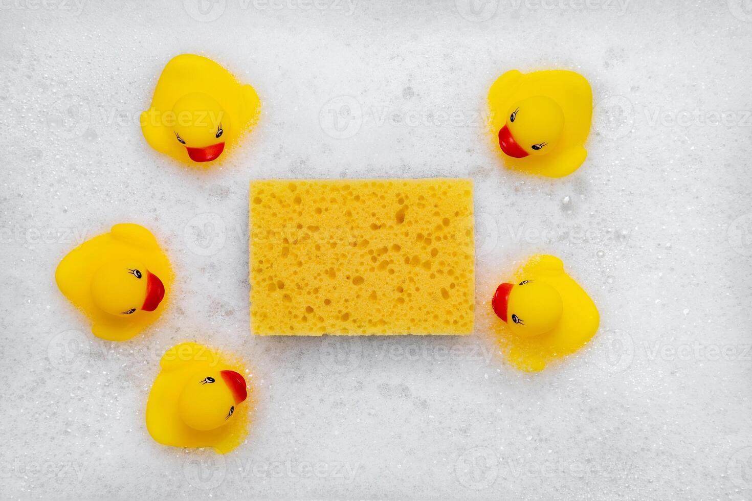 High Angle View of yellow rubber duck in bath swimming in foam w photo
