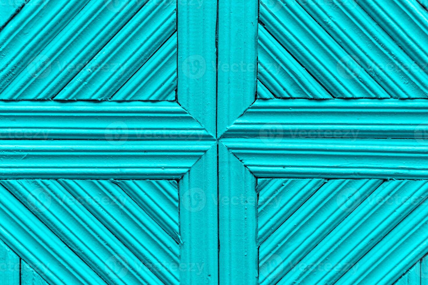 Light blue wooden background made of planks tightly knitted together. Simple geometric pattern with cross and diagonal lines. photo