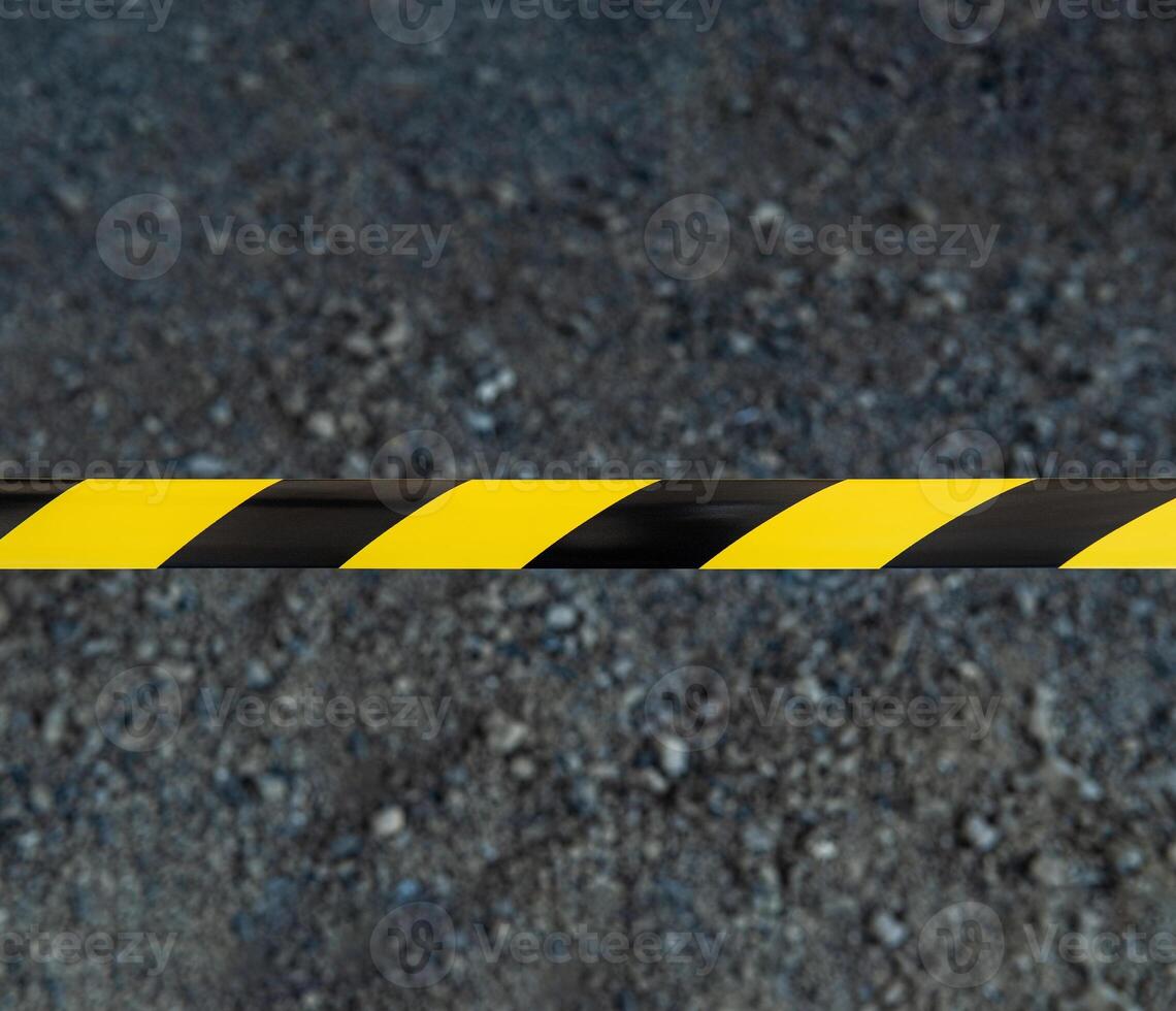 Black and yellow striped tapes on dark back. Restricted area border. Passage is forbidden. photo