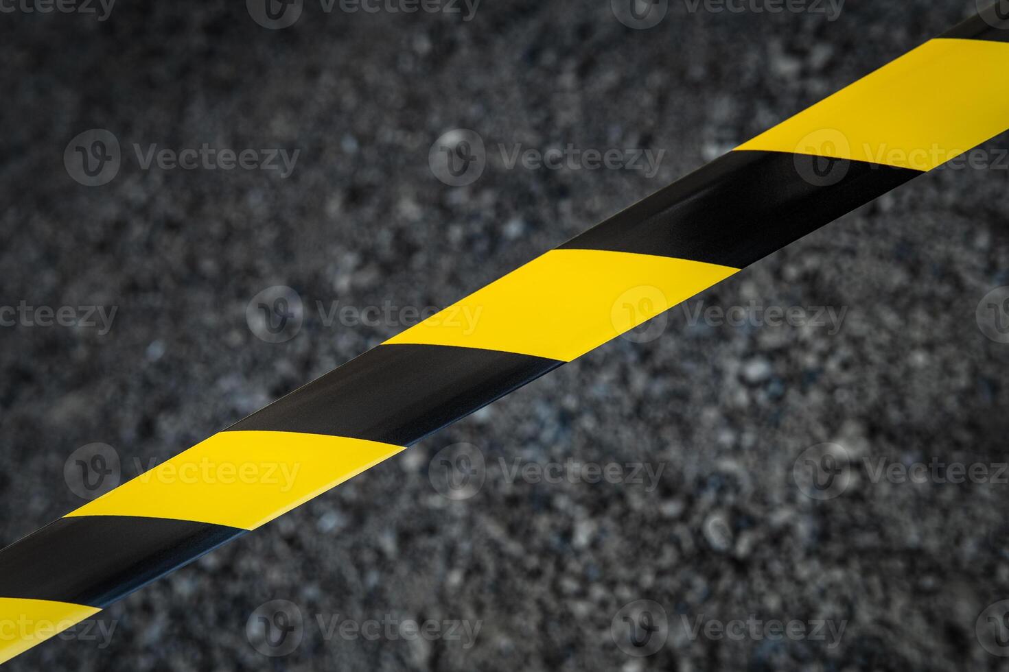 Black and yellow striped tapes on dark back. Restricted area border. Passage is forbidden. photo