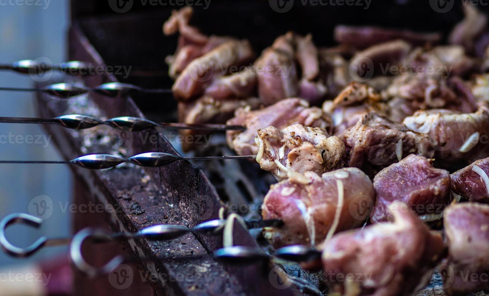 Fresh shish kebab on skewers is fried on the grill. Grilled meat on skewers. photo