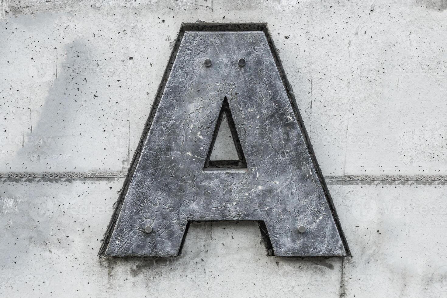 dark gray letter a on concrete background photo