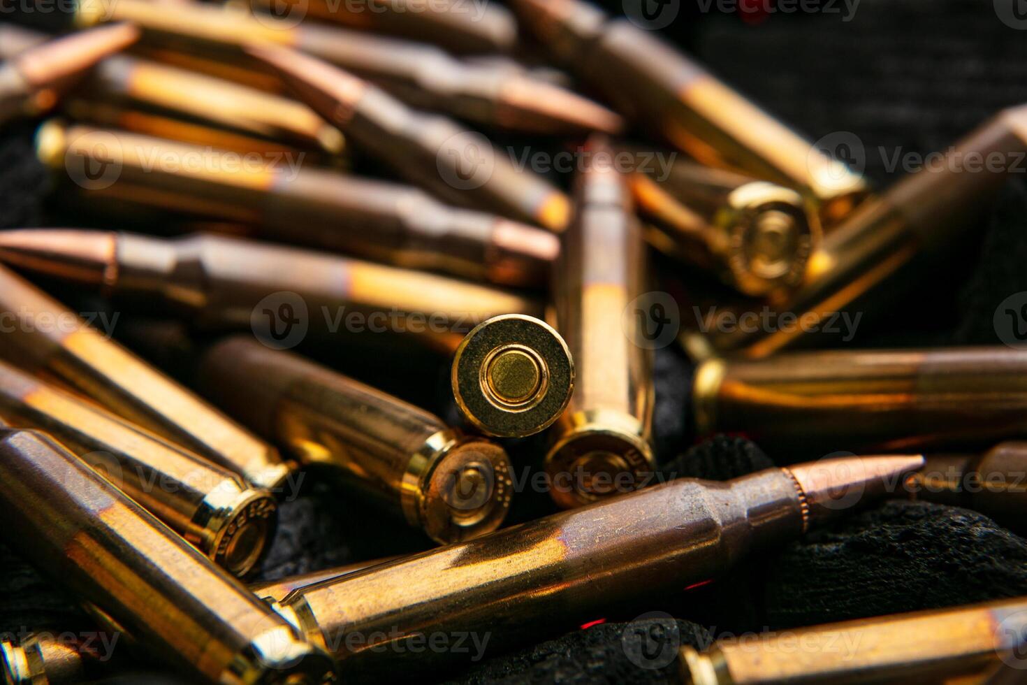 Cartridges for automatic carbine caliber .223 on charcoal. Ammunition for automatic and semi-automatic rifles. Dark back. photo