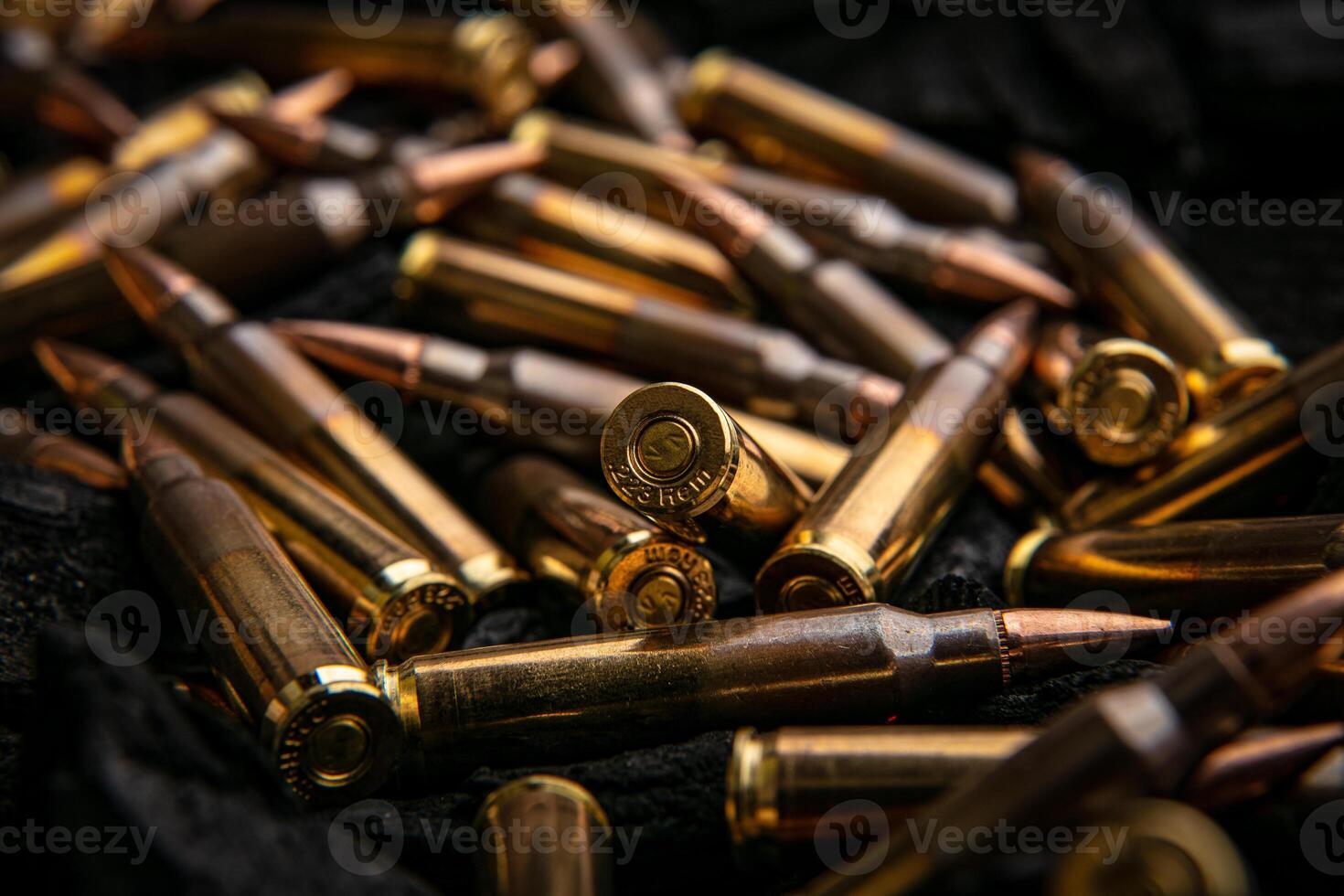 Cartridges for automatic carbine caliber .223 on charcoal. Ammunition for automatic and semi-automatic rifles. Dark back. photo