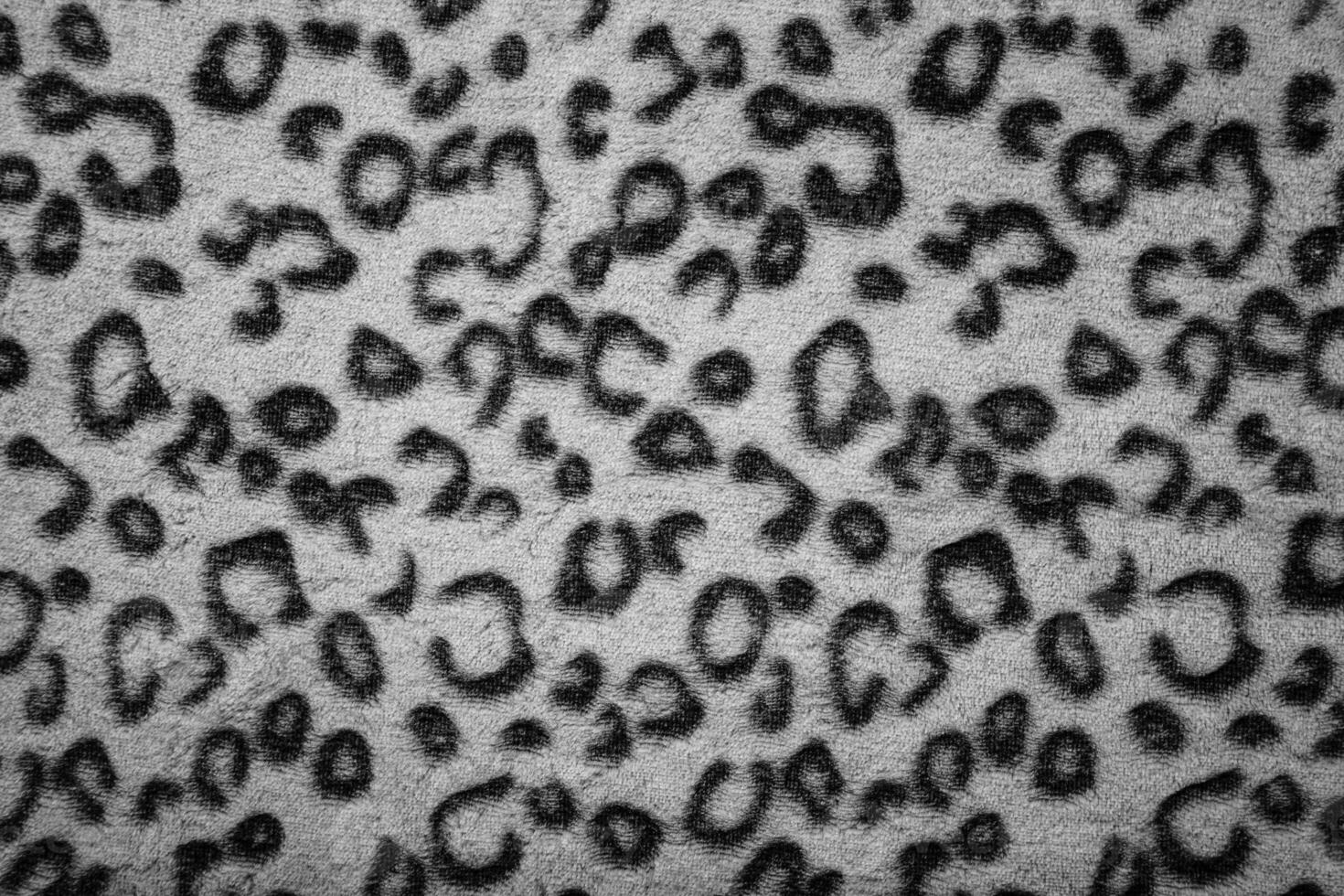 Soft fleecy faux fabric with a mottled pattern. Light leopard texture. photo