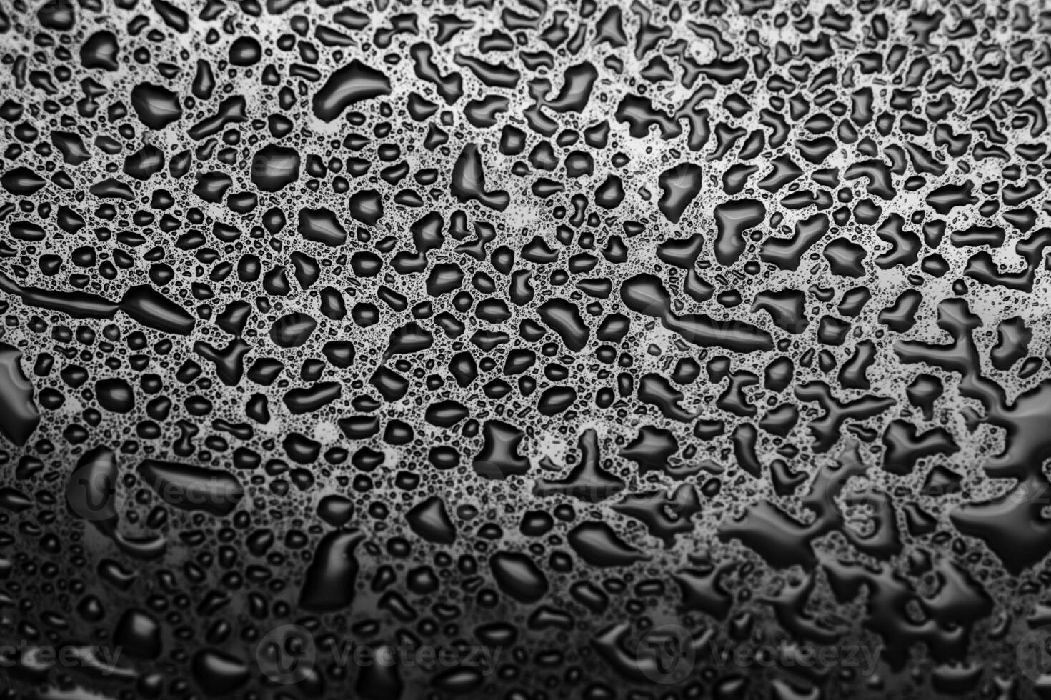 Shiny water drops on a dark glass. Water drops on black surface. photo