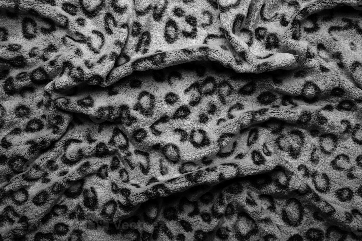 Soft fleecy faux fabric with a mottled pattern. Light leopard texture. photo