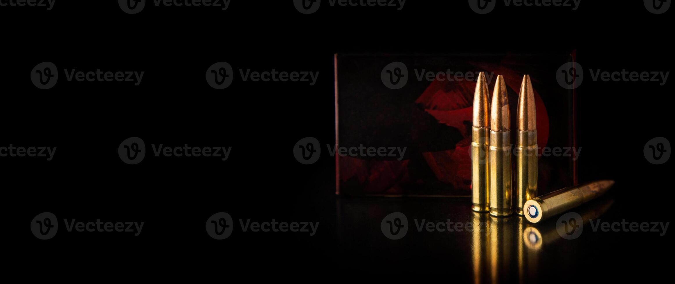 Bullet isolated on black background with reflexion. Rifle bullets close-up on black back. Cartridges for rifle and carbine on a black. photo