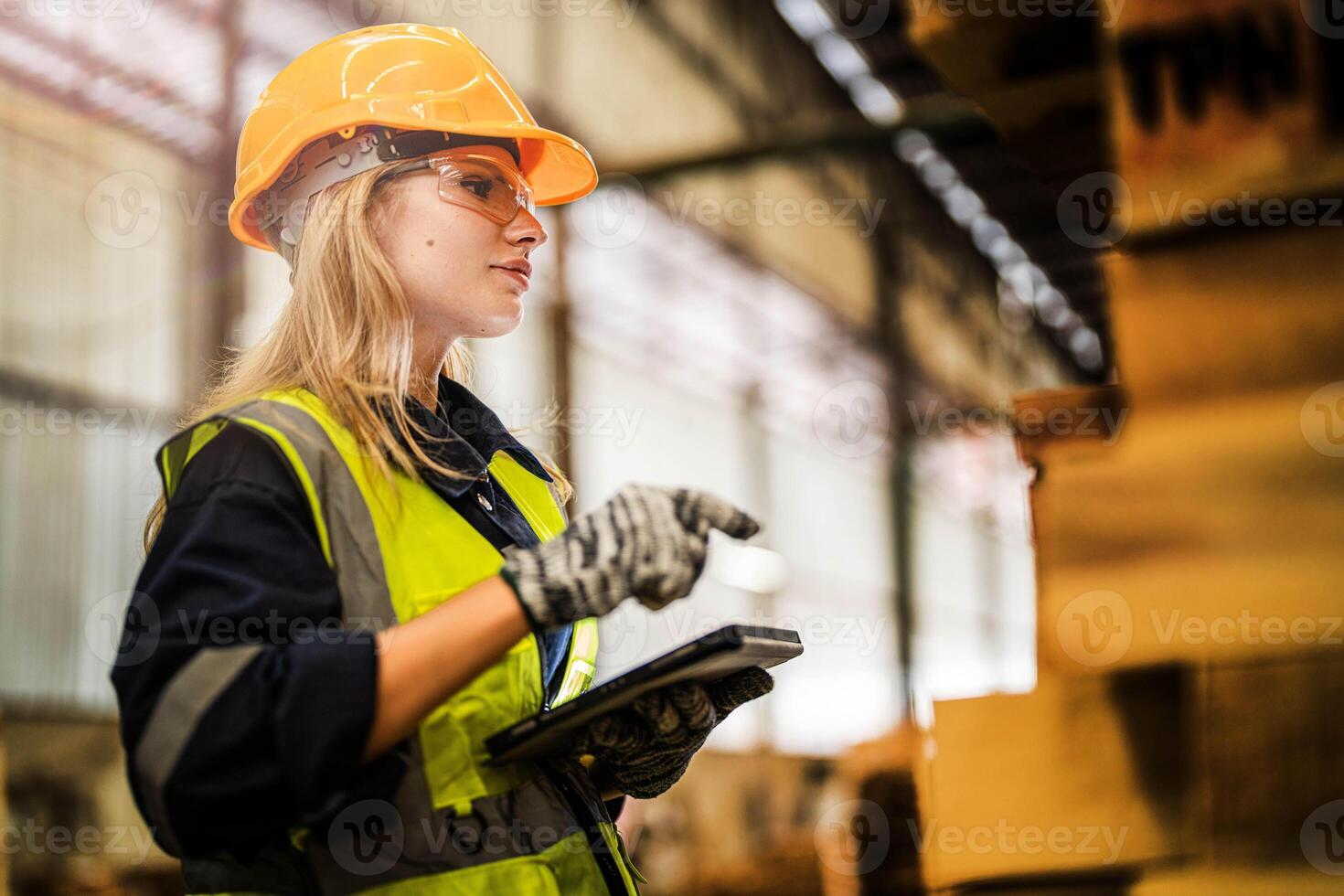 woman worker carpenter wearing safety uniform and hard hat working and checking the quality of wooden products at workshop manufacturing. man and woman workers wood in dark warehouse industry. photo