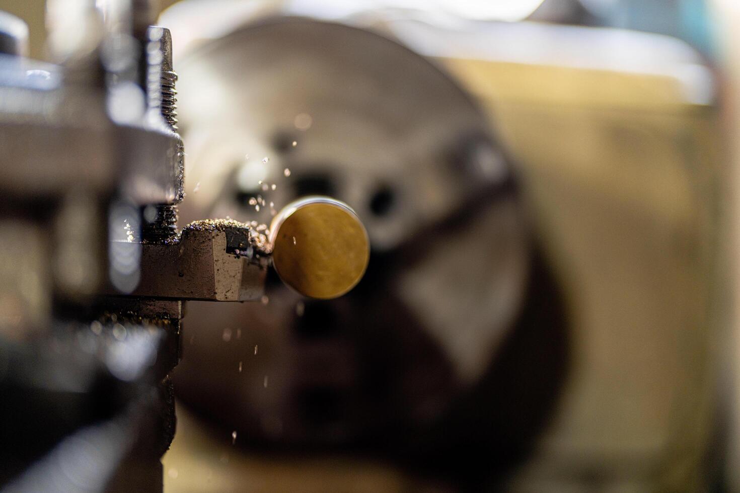 close up of machine operation for Metal Lathes. The steel column rolling in machine. metalworking industry. finishing metal working internal steel surface on lathe grinder machine with flying sparks photo