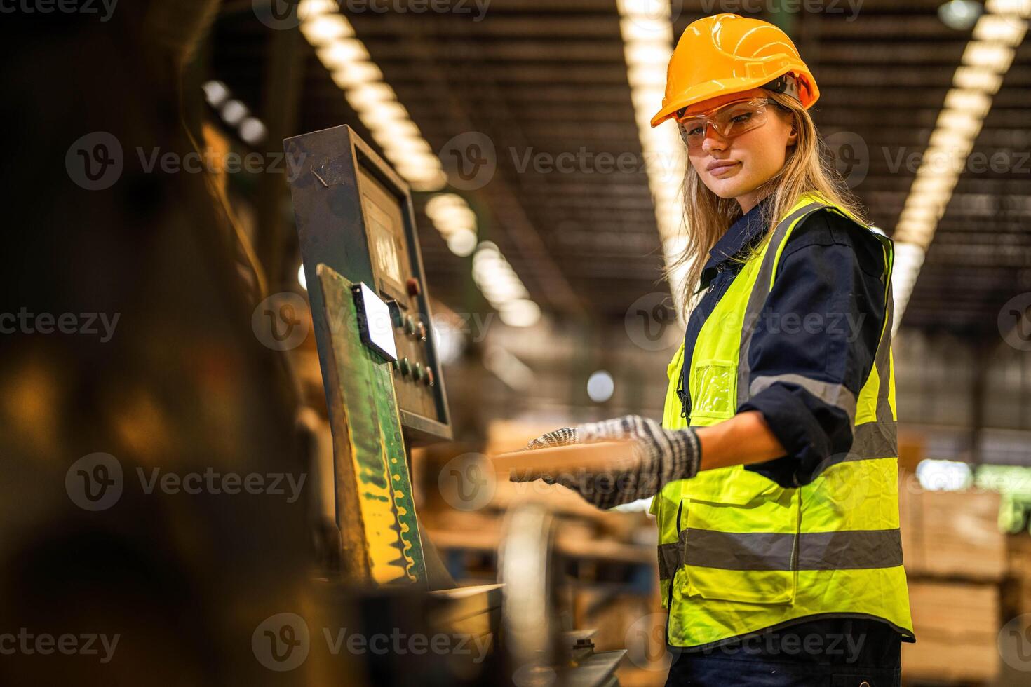 Factory engineer woman standing confident to control panel switch. Worker works at heavy machine at industry factory. worker checking timber of raw wood material. smart industry worker operating. photo