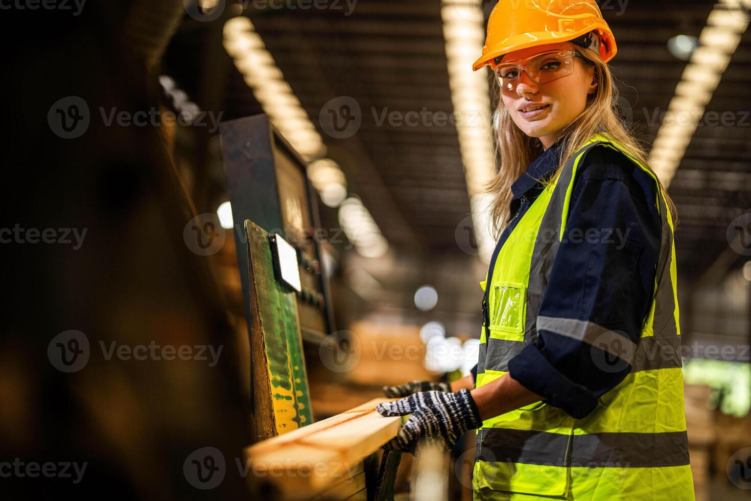 Factory engineer woman standing confident to control panel switch. Worker works at heavy machine at industry factory. worker checking timber of raw wood material. smart industry worker operating. photo