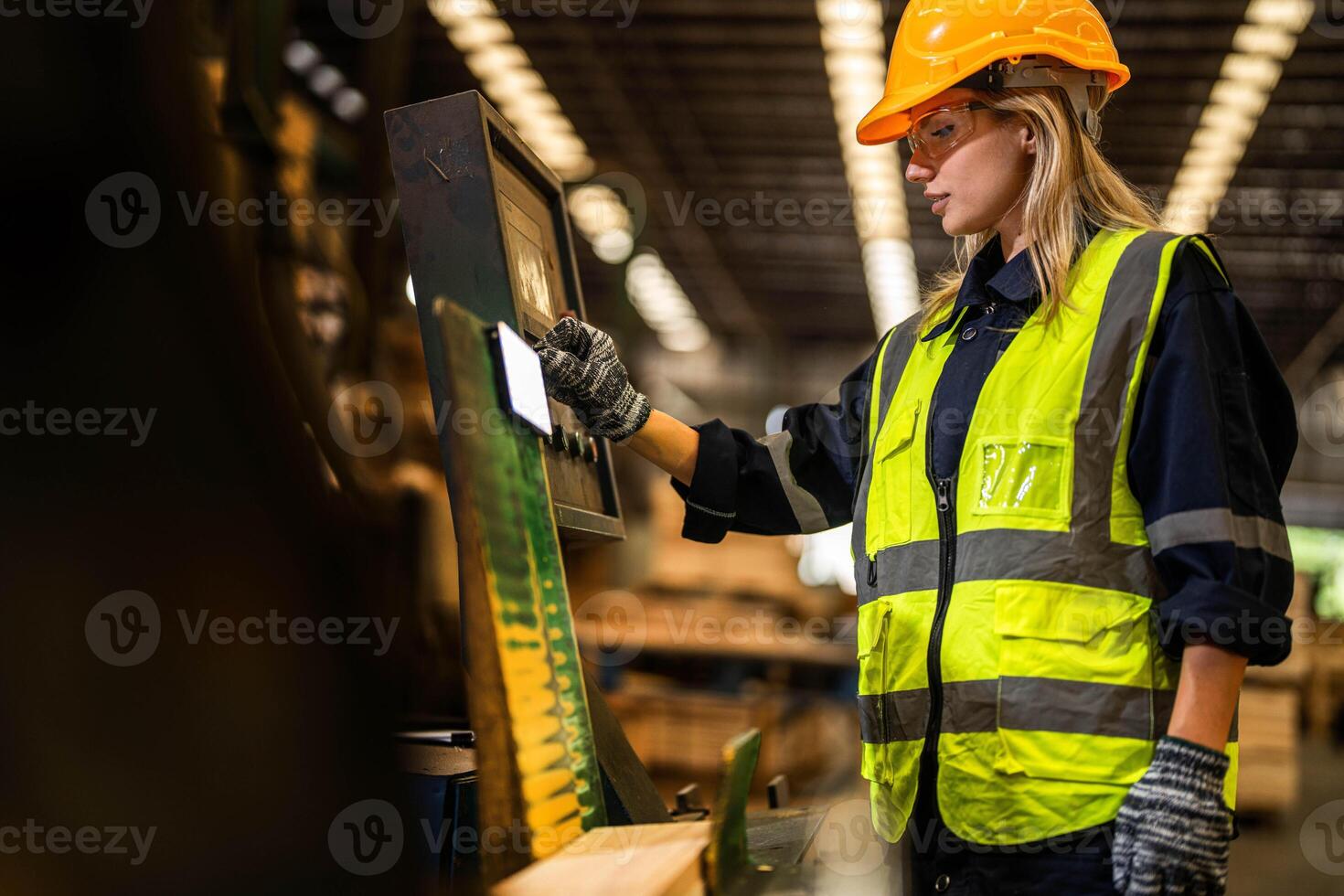 Factory engineer woman standing confident to control panel switch. Worker works at heavy machine at industry factory. worker checking timber of raw wood material. smart industry worker operating. photo
