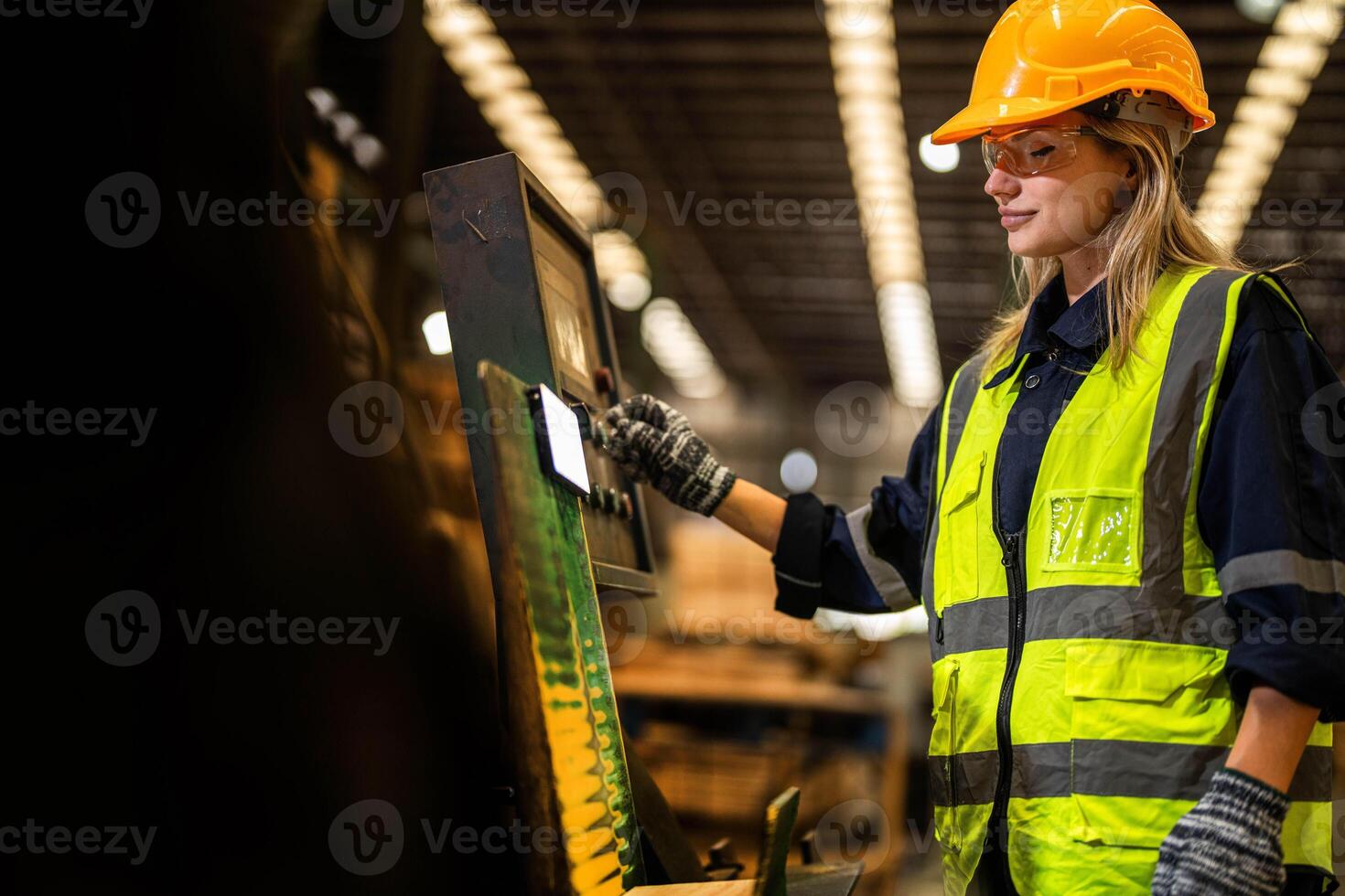 Factory engineer woman standing confident to control panel switch. Worker works at heavy machine at industry factory. worker checking timber of raw wood material. smart industry worker operating. photo