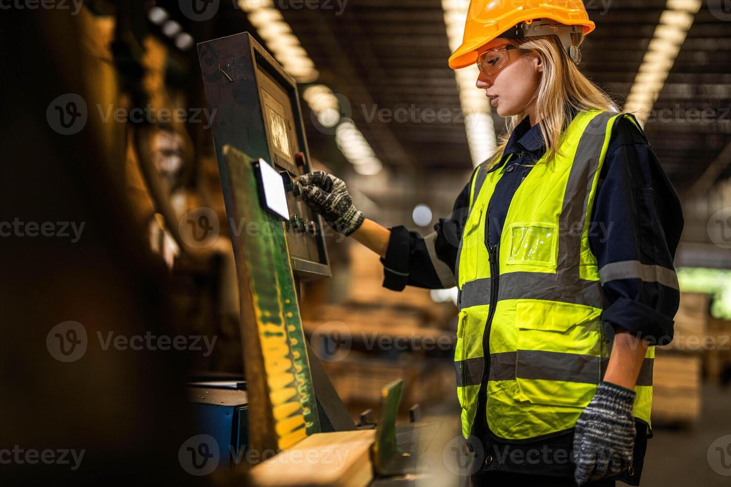 Factory engineer woman standing confident to control panel switch. Worker works at heavy machine at industry factory. worker checking timber of raw wood material. smart industry worker operating. photo