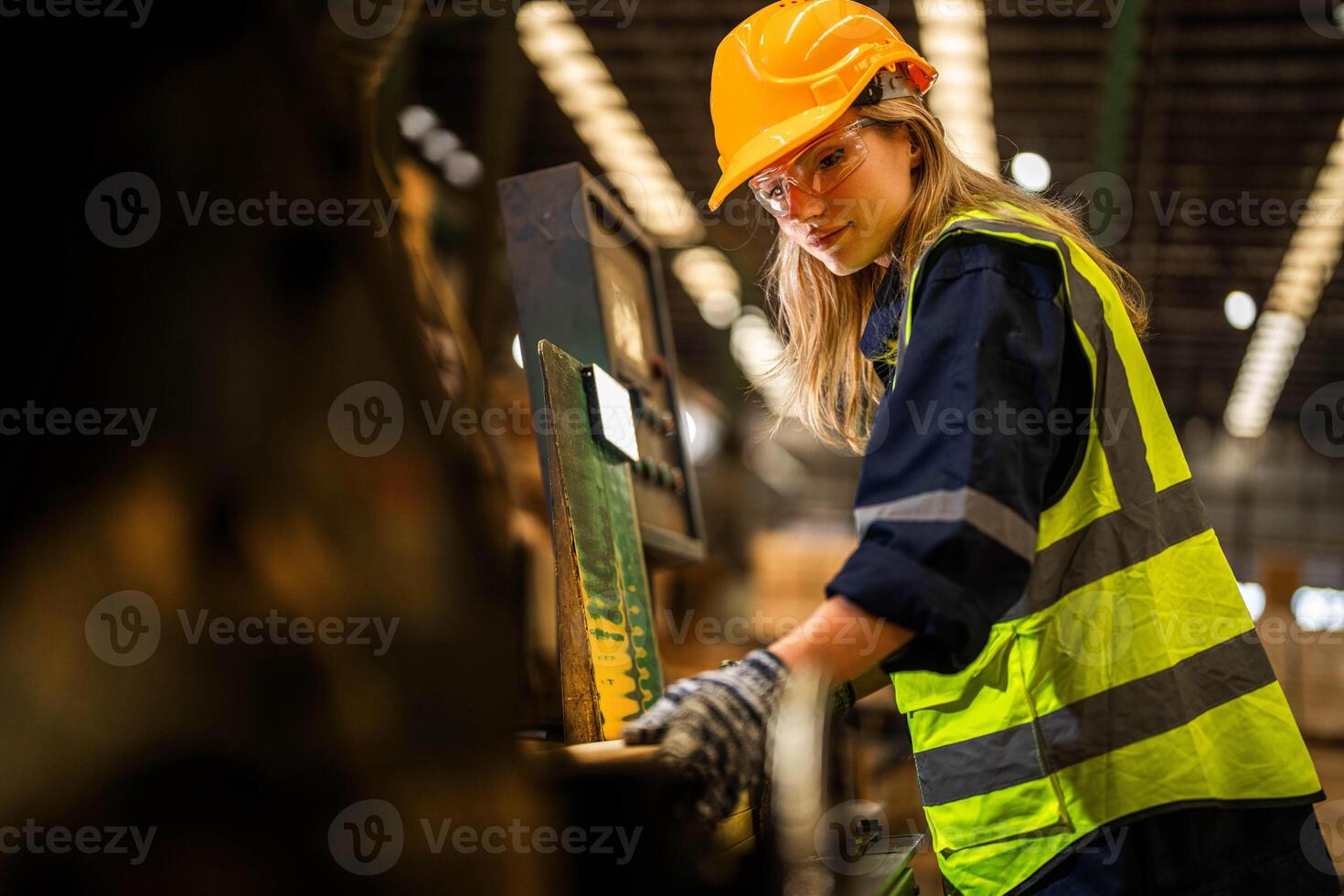 Factory engineer woman standing confident to control panel switch. Worker works at heavy machine at industry factory. worker checking timber of raw wood material. smart industry worker operating. photo