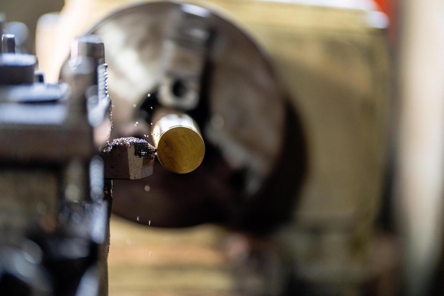 close up of machine operation for Metal Lathes. The steel column rolling in machine. metalworking industry. finishing metal working internal steel surface on lathe grinder machine with flying sparks photo