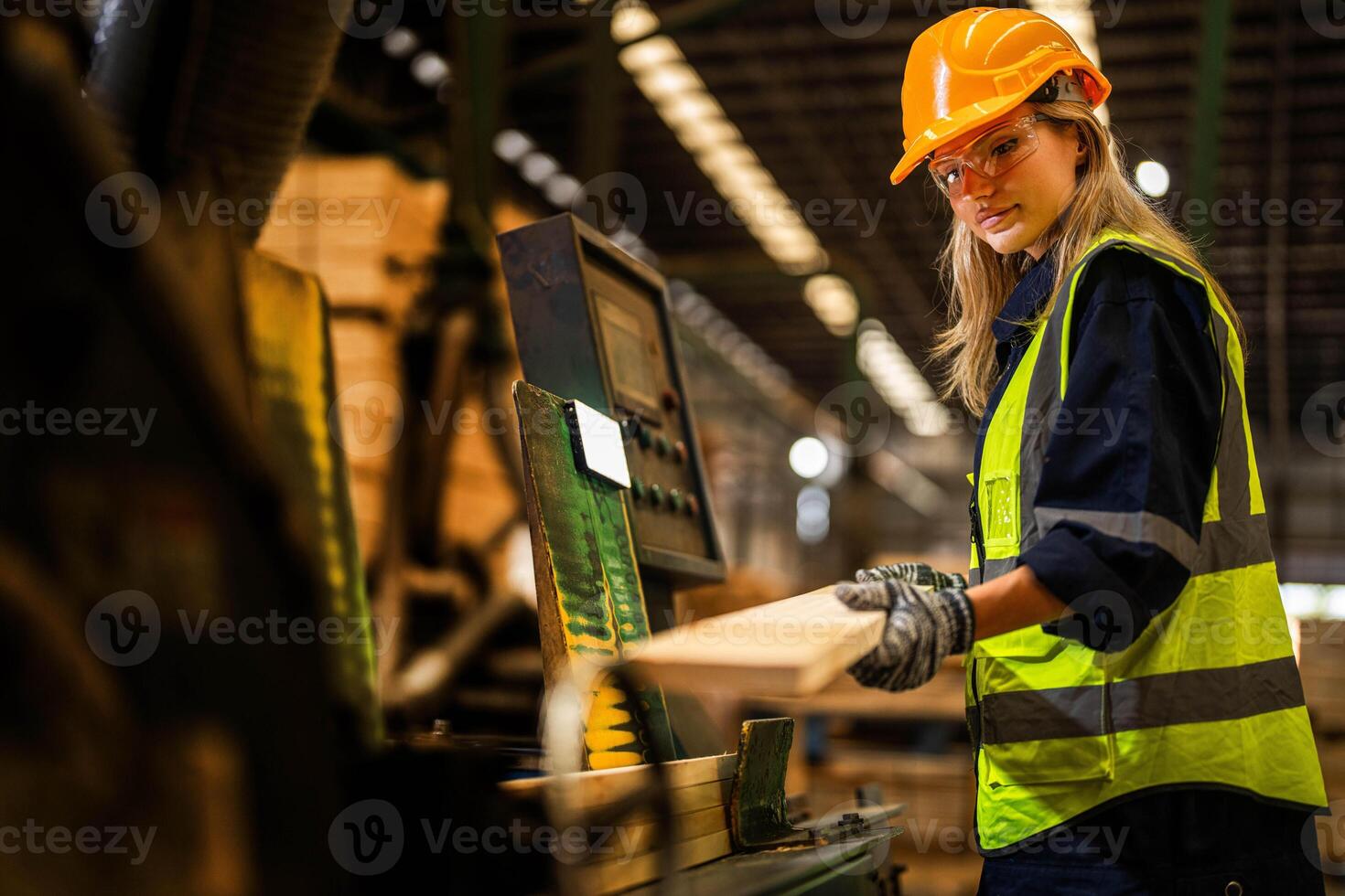 Factory engineer woman standing confident to control panel switch. Worker works at heavy machine at industry factory. worker checking timber of raw wood material. smart industry worker operating. photo